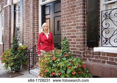 A young woman stands at the front door of her home, Charleston, South Carolina, USA View Large Photo Image Stock Image - A young woman stands at the front door of her home, Charleston, South Carolina, USA. Fotosearch