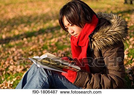 A young woman student studies on campus in Autumn View Large Photo Image Stock Photo - A young woman student studies on campus in Autumn. Fotosearch