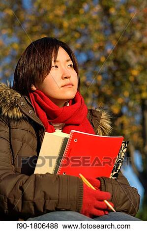 A young woman student studies on campus in Autumn View Large Photo Image Stock Photo - A young woman student studies on campus in Autumn. Fotosearch
