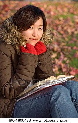 A young woman student studies on campus in Autumn View Large Photo Image Stock Photograph - A young woman student studies on campus in Autumn. Fotosearch