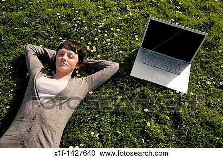 A young woman UK university student with her apple laptop computer outdoors on a sunny warm day View Large Photo Image Stock Image - A young woman UK university student with her apple laptop computer outdoors on a sunny warm day. Fotosearch