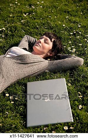 A young woman UK university student with her apple laptop computer outdoors on a sunny warm day View Large Photo Image Stock Image - A young woman UK university student with her apple laptop computer outdoors on a sunny warm day. Fotosearch