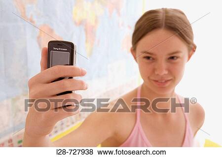 Stock Photo - a young woman using mobile phone. Fotosearch