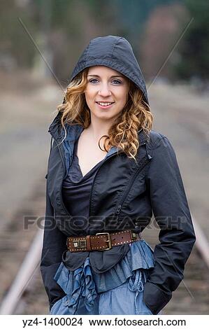 A young woman walking on train tracks View Large Photo Image Picture - A young woman walking on train tracks. Fotosearch