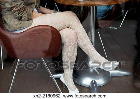 A young woman wears lace stockings in a cafe in Moscow, Russia. View Large Photo Image Stock Image - A young woman wears lace stockings in a cafe in Moscow, Russia.. Fotosearch