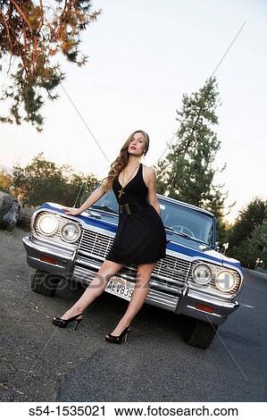 A young woman with a 1964 Chevrolet Impala in Spokane, Washington, USA. View Large Photo Image Stock Image - A young woman with a 1964 Chevrolet Impala in Spokane, Washington, USA.. Fotosearch