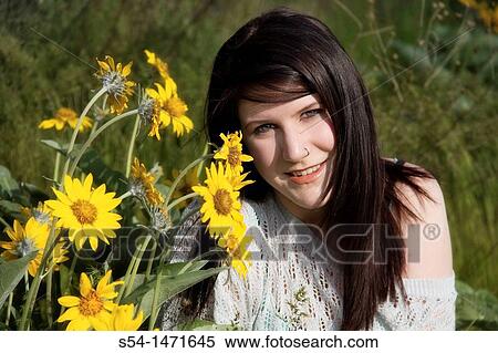 A young woman with Arrowleaf Balsamroot outdoors. View Large Photo Image Stock Photography - A young woman with Arrowleaf Balsamroot outdoors.. Fotosearch