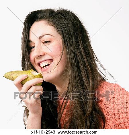 A young woman with brown hair and eyes eating a fresh pear fruit View Large Photo Image Stock Image - A young woman with brown hair and eyes eating a fresh pear fruit. Fotosearch