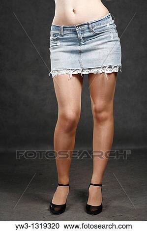 A young women wearing a jeans skirt only legs View Large Photo Image Stock Image - A young women wearing a jeans skirt only legs. Fotosearch