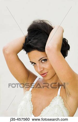 A youngish 20, 25, 30 woman holds hair and arms above her head while wearing a white lace top. View Large Photo Image Stock Image - A youngish 20, 25, 30 woman holds hair and arms above her head while wearing a white lace top.. Fotosearch