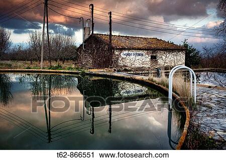 Abandoned house reflected in the water of a reservoir Tarragona, Spain View Large Photo Image Stock Image - Abandoned house reflected in the water of a reservoir Tarragona, Spain. Fotosearch