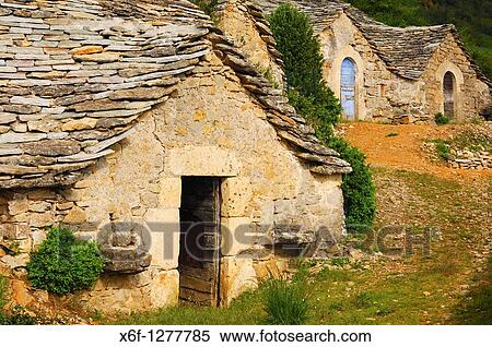 Abandoned semitroglodyte wine cellars with a natural stone roof in Entre-deux-Monts near Riviere-sur-Tarn, Aveyron, France View Large Photo Image Stock Photography - Abandoned semitroglodyte wine cellars with a natural stone roof in Entre-deux-Monts near Riviere-sur-Tarn, Aveyron, France. Fotosearch