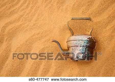 Abandoned tea pot in the Argelian desert. Hamada of Tinduf. Half covered by sand. Tinduf. Argelia. View Large Photo Image Stock Photo - Abandoned tea pot in the Argelian desert. Hamada of Tinduf. Half covered by sand. Tinduf. Argelia.. Fotosearch
