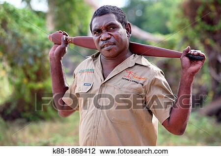 Stock Image - Aboriginal Tour Guide demonstrating a Woomera spear throwerin Kakadu National Park Northern Territory, Australia. Fotosearch