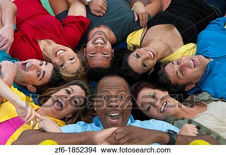 Abstract from above of many multi ethnic friends in playground laughing and sharing fun in spinning wheel of colors together View Large Photo Image Picture - Abstract from above of many multi ethnic friends in playground laughing and sharing fun in spinning wheel of colors together. Fotosearch