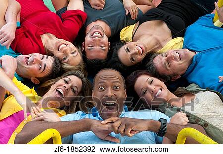 Abstract from above of many multi ethnic friends in playground laughing and sharing fun in spinning wheel of colors together View Large Photo Image Stock Image - Abstract from above of many multi ethnic friends in playground laughing and sharing fun in spinning wheel of colors together. Fotosearch