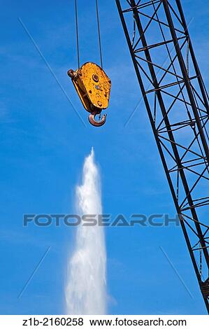 Stock Photo - Abstract image of the Jet d'eau fountain and a crane hook, Geneva, Switzerland.. Fotosearch