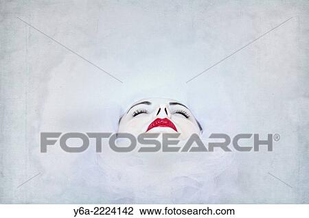 Stock Image - Abstract view of young woman wearing red lipstick, close-up.. Fotosearch