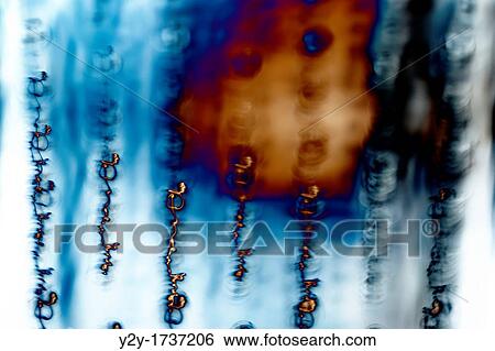 Stock Photograph - Abstraction in blue and metalic orange. Fotosearch