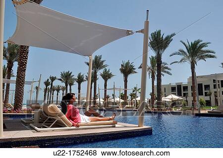 Abu Dhabi, United Arab Emirates: woman at the swimming pool of Hotel Park Hyatt Abu Dhabi, Saadiyat Island View Large Photo Image Stock Photo - Abu Dhabi, United Arab Emirates: woman at the swimming pool of Hotel Park Hyatt Abu Dhabi, Saadiyat Island. Fotosearch