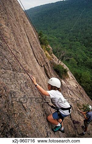 Stock Photograph - Acadia National Park, Maine - Mariel West, 13, learns rock climbing while her instructor belays her from below MR. Fotosearch