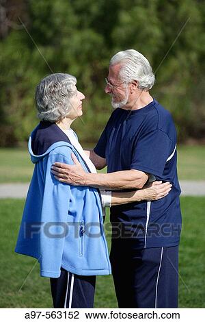 Active senior couple in exercise clothes embrace each other in an outdoor park. View Large Photo Image Stock Image - Active senior couple in exercise clothes embrace each other in an outdoor park.. Fotosearch