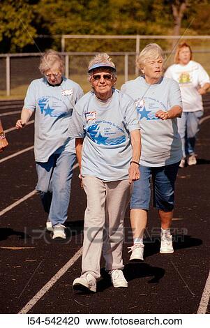 Active Senior men and women participate in the Senior Olympic qualifying track and field games held at Port Huron Michigan View Large Photo Image Stock Image - Active Senior men and women participate in the Senior Olympic qualifying track and field games held at Port Huron Michigan. Fotosearch