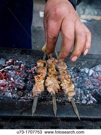 Adding spices to the kebabs View Large Photo Image Stock Image - Adding spices to the kebabs. Fotosearch
