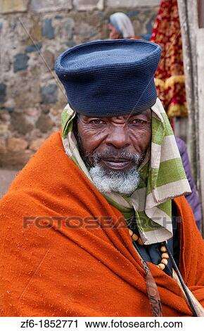Addis Ababa Ethiopia Africa old religious man portrait aged 70 in orange and robe in Shero Meda area 2 View Large Photo Image Stock Image - Addis Ababa Ethiopia Africa old religious man portrait aged 70 in orange and robe in Shero Meda area 2. Fotosearch