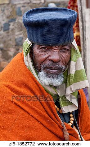 Addis Ababa Ethiopia Africa old religious man portrait aged 70 in orange and robe in Shero Meda area 2 View Large Photo Image Stock Image - Addis Ababa Ethiopia Africa old religious man portrait aged 70 in orange and robe in Shero Meda area 2. Fotosearch