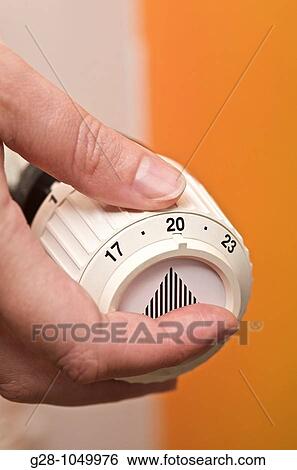 adjusting and lowering room temperature for energy economy on radiator thermostat View Large Photo Image Stock Photograph - adjusting and lowering room temperature for energy economy on radiator thermostat. Fotosearch