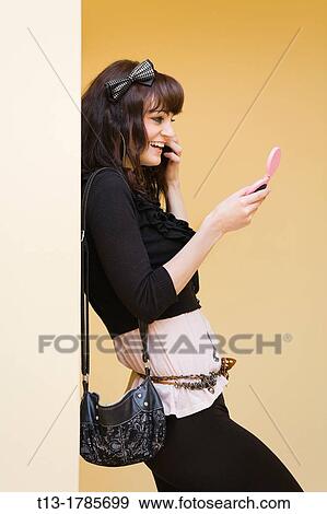 Adjusting hair young woman View Large Photo Image Stock Photo - Adjusting hair young woman. Fotosearch