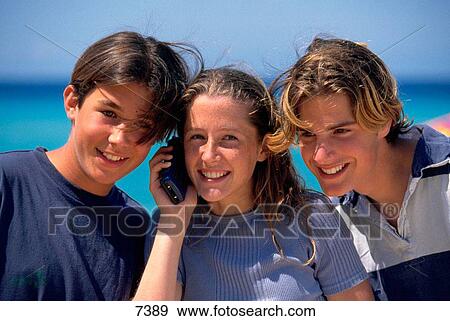 Adolescents with mobile phone View Large Photo Image Stock Photo - Adolescents with mobile phone. Fotosearch