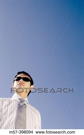 Picture - Adult Asian Male wearing dark sun glasses and shirt and tie.. Fotosearch