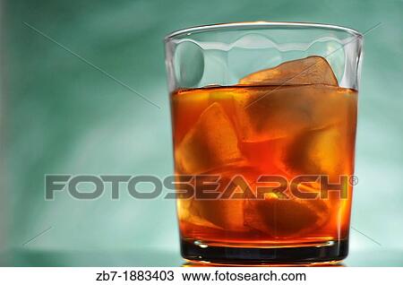 Stock Image - Adult beverage with green back-lite background. Fotosearch