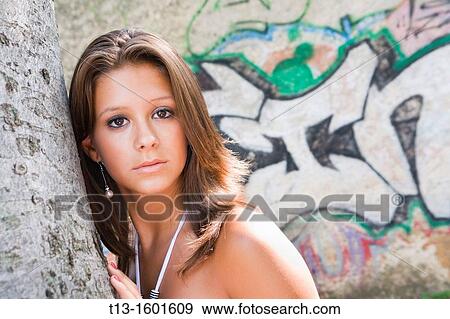Adult girl portrait before a colorful wall graffiti View Large Photo Image Stock Photo - Adult girl portrait before a colorful wall graffiti. Fotosearch