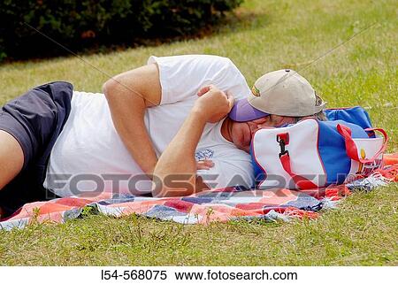 Adult male cat napping outside on the ground View Large Photo Image Stock Photography - Adult male cat napping outside on the ground. Fotosearch