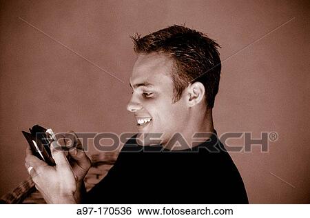 Stock Photograph - Adult man using pda. Fotosearch