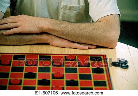 Adult playing checkers View Large Photo Image Stock Photograph - Adult playing checkers. Fotosearch
