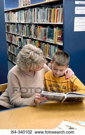 Adult woman with grandchild reading at a library. View Large Photo Image Stock Image - Adult woman with grandchild reading at a library.. Fotosearch