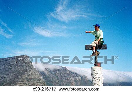 Adventurer on top looking at mountains. South Africa View Large Photo Image Stock Photo - Adventurer on top looking at mountains. South Africa. Fotosearch