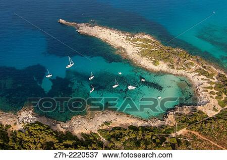 Stock Photo - Aerial shot of a beach with anchored boats in the northeast of Mallorca (Majorca, Balearic Island).. Fotosearch