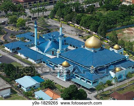 Aerial view of a bright blue mosque in Johor, Malaysia iwht a maintenance man on a crane View Large Photo Image Stock Photography - Aerial view of a bright blue mosque in Johor, Malaysia iwht a maintenance man on a crane. Fotosearch