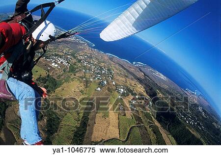 Aerial view of a tandem paraglider pilots over sugar cane fields near Saint Leu. Reunion island (archipelago of Mascarenhas), French department island, Indian Ocean, Africa View Large Photo Image Stock Photography - Aerial view of a tandem paraglider pilots over sugar cane fields near Saint Leu. Reunion island (archipelago of Mascarenhas), French department island, Indian Ocean, Africa. Fotosearch