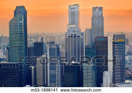 Aerial view of Central Business District at sunset Most of this buildings host regional headquarters of banks and financial institutions such as Mmaybank, Capita Commercial, Straits Trading, HSBC, ANZ, Bank of America and Merrill Lynch Singapore View Large Photo Image Stock Image - Aerial view of Central Business District at sunset Most of this buildings host regional headquarters of banks and financial institutions such as Mmaybank, Capita Commercial, Straits Trading, HSBC, ANZ, Bank of America and Merrill Lynch Singapore. Fotosearch
