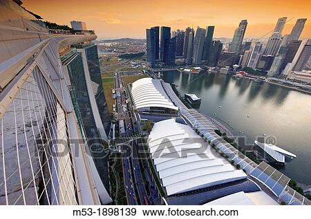 Aerial view of Central Business District at sunset On the left had side skyscrapers of major banks such as Bank of China, MayBank and HSBC The large structure on the bottom foreground is Marina Bay Sands Complex View Large Photo Image Stock Photo - Aerial view of Central Business District at sunset On the left had side skyscrapers of major banks such as Bank of China, MayBank and HSBC The large structure on the bottom foreground is Marina Bay Sands Complex. Fotosearch