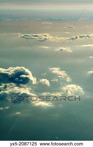 Aerial view of clouds in the sky from an airplane View Large Photo Image Stock Photography - Aerial view of clouds in the sky from an airplane. Fotosearch