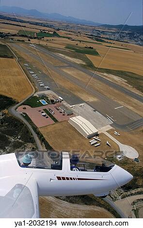 Aerial view of glider plane Twin Astir flying over aerodrome of Santa Cilia de Jaca, Aragon, Spain. View Large Photo Image Picture - Aerial view of glider plane Twin Astir flying over aerodrome of Santa Cilia de Jaca, Aragon, Spain.. Fotosearch