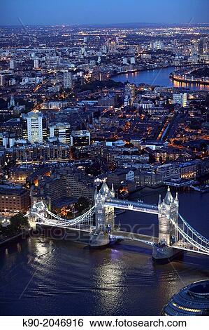 Stock Photograph - Aerial view of London at night with the Tower Bridge in the foreground, England, Great Britain, United Kingdom, Europe.. Fotosearch