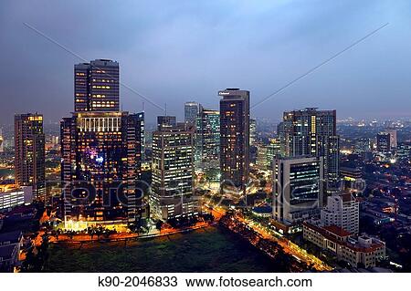 Stock Image - Aerial view of office buildings at night, Jakarta, Java, Indonesia, Southeast Asia.. Fotosearch